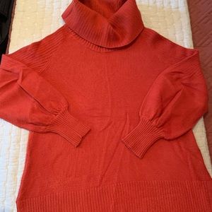 Reddish orange turtle neck sweater from Anthropologie